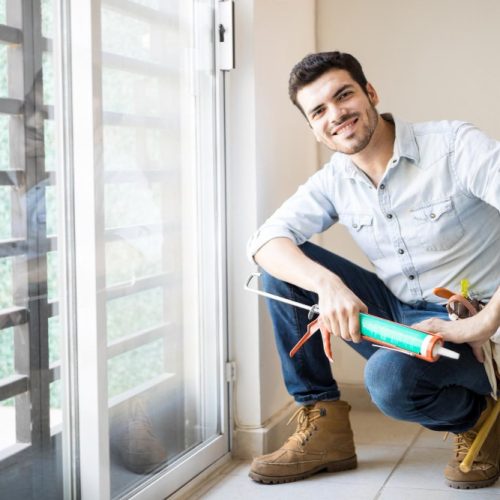 good-looking-young-handyman-just-finished-sealing-door-frame-looking-satisfied-with-his-work (1) good-looking-young-handyman-just-finished-sealing-door-frame-looking-satisfied-with-his-work (1)