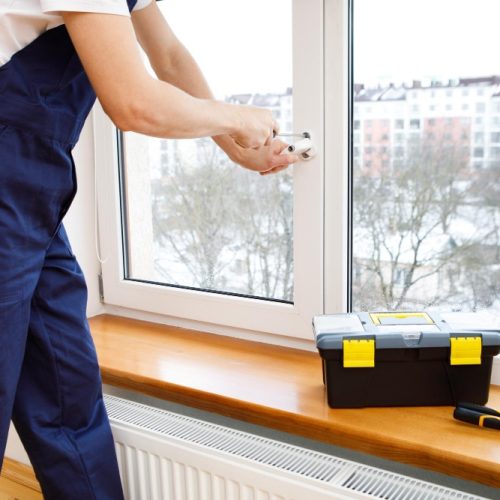 worker-installing-checking-window-house worker-installing-checking-window-house